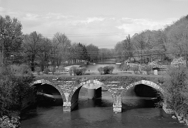 Dry-stone arch bridge symbolizing permanent mechanical integrity